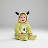 Twinkles baby wearing a lime green fleece monster jumpsuit with a hood, black horns, and a large eye graphic