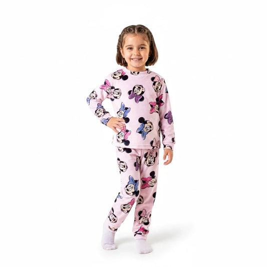 Young girl wearing a Twinkles Minnie Mouse pink long-sleeve pajama set with a cute character print